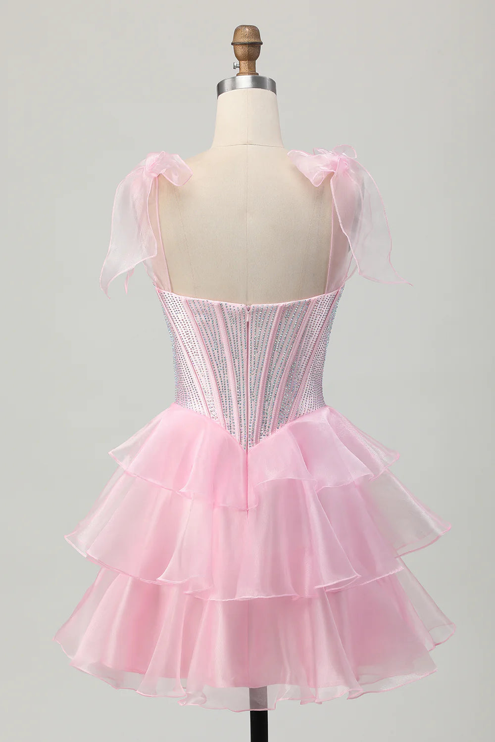 Side view of the pink tiered beaded homecoming dress, showcasing the A-line skirt and corset detail.