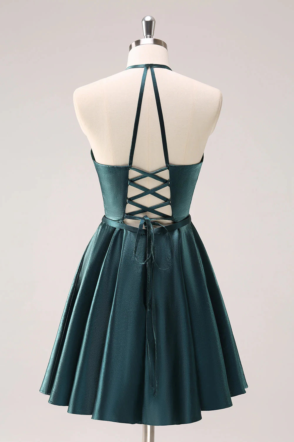 Side view of peacock blue A-line halter short dress.