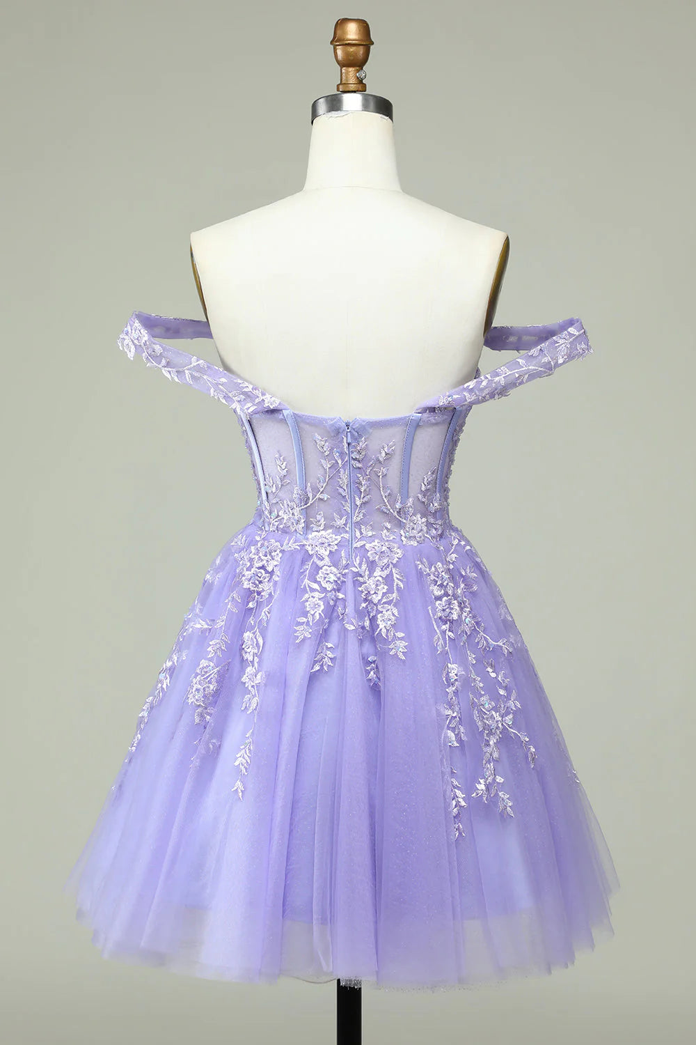 Side view of a model in a lilac A-line off-shoulder short homecoming dress, showcasing the appliques.