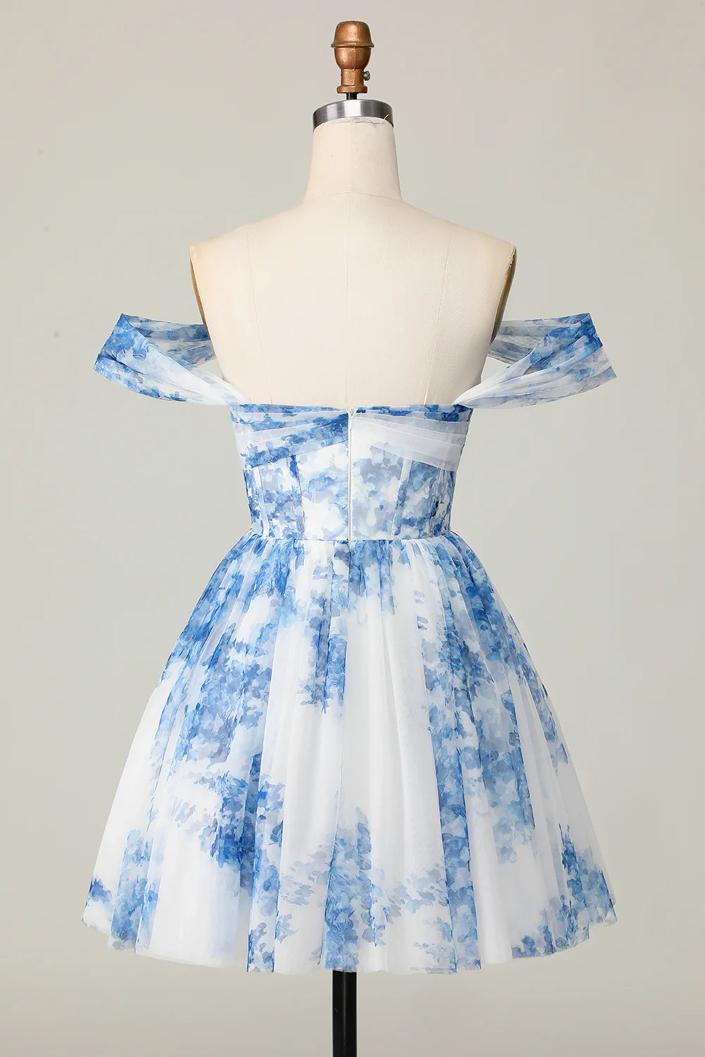Model wearing white and blue floral off-shoulder homecoming dress.