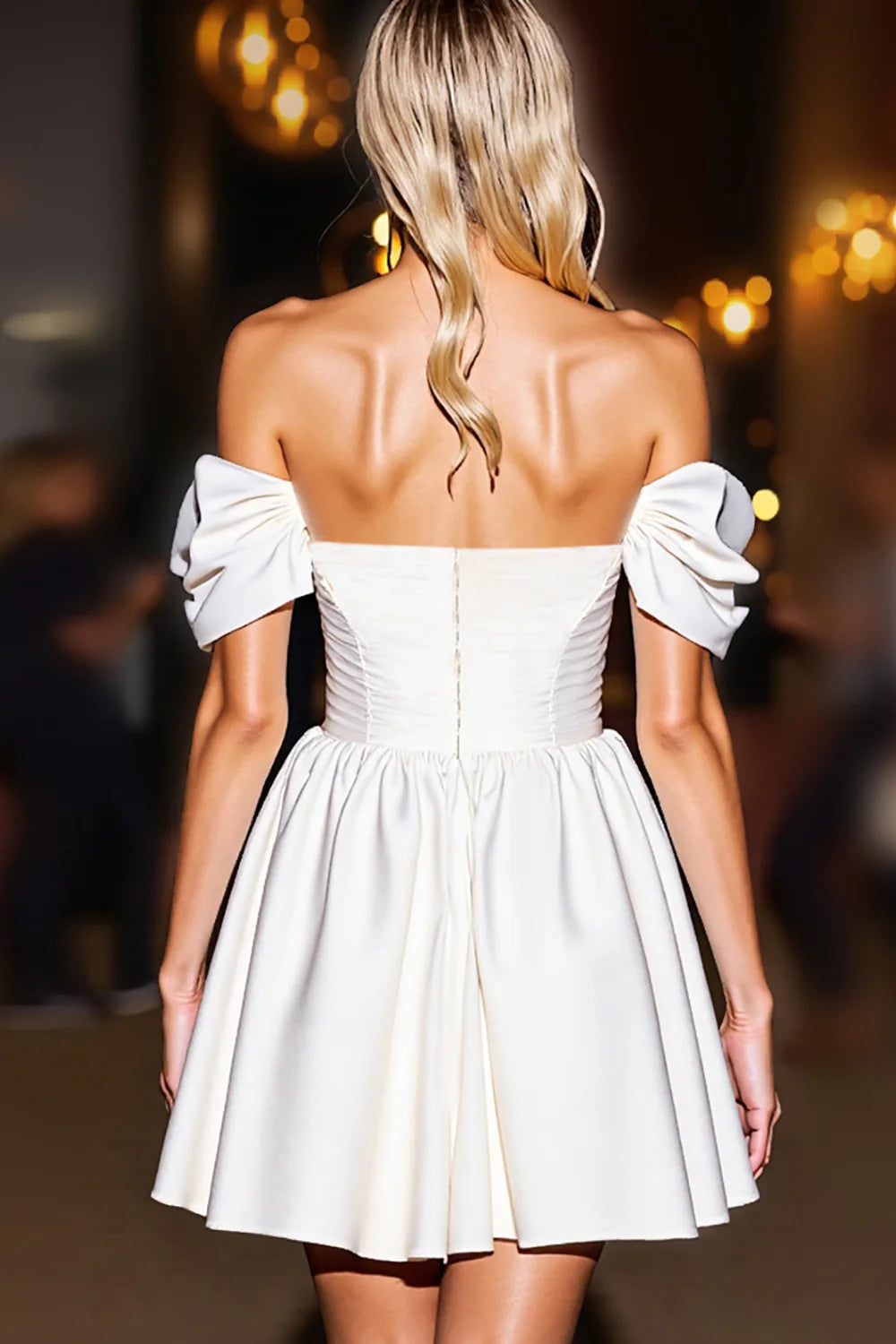 Back view of a model in the white off-the-shoulder A-line dress.