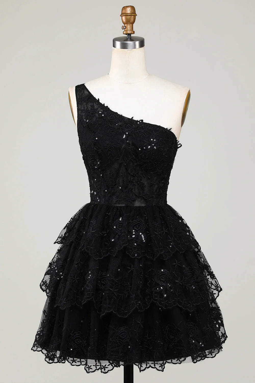 Black one-shoulder tiered short homecoming dress with appliques.