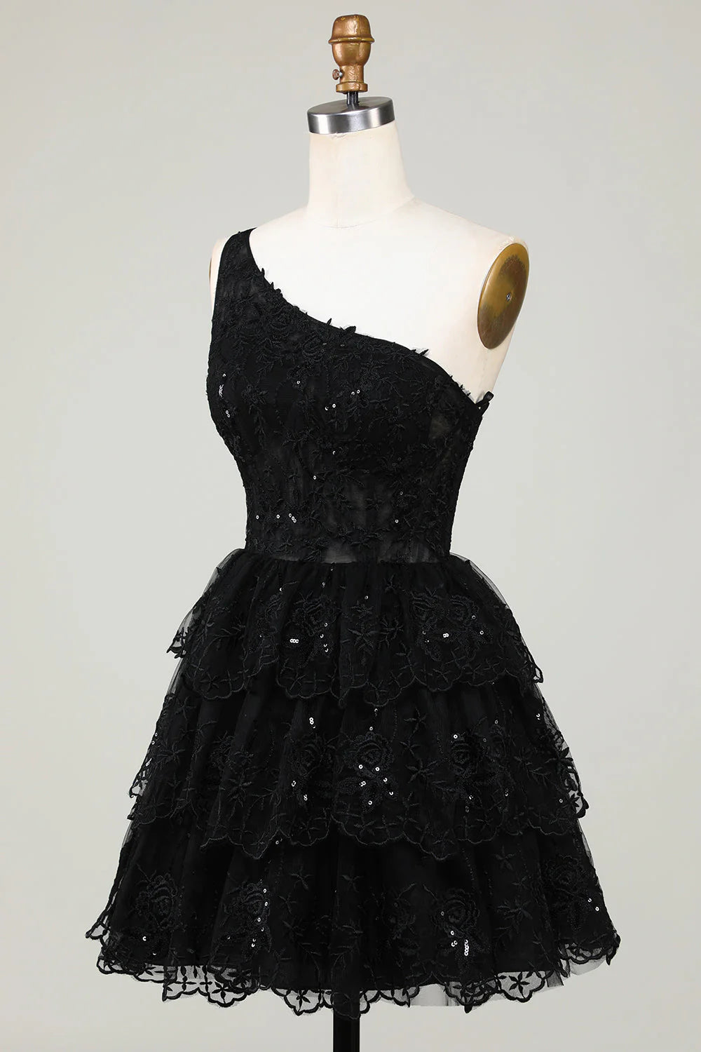 Back view of black one-shoulder tiered short homecoming dress.