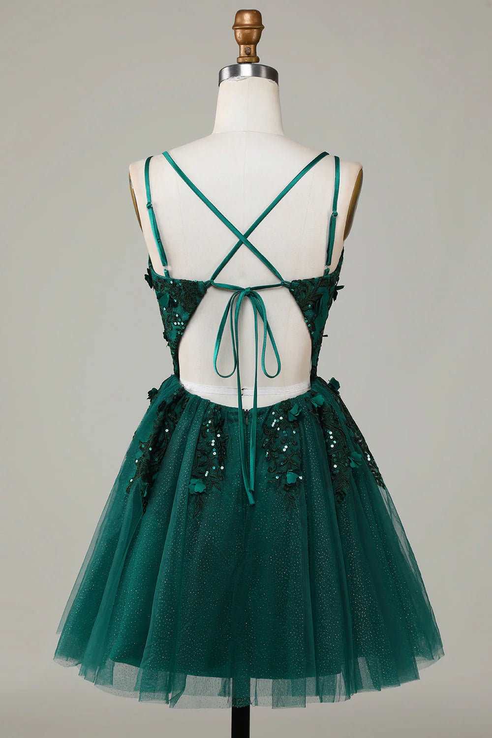 Back view of the dark green short homecoming dress, showing spaghetti straps.