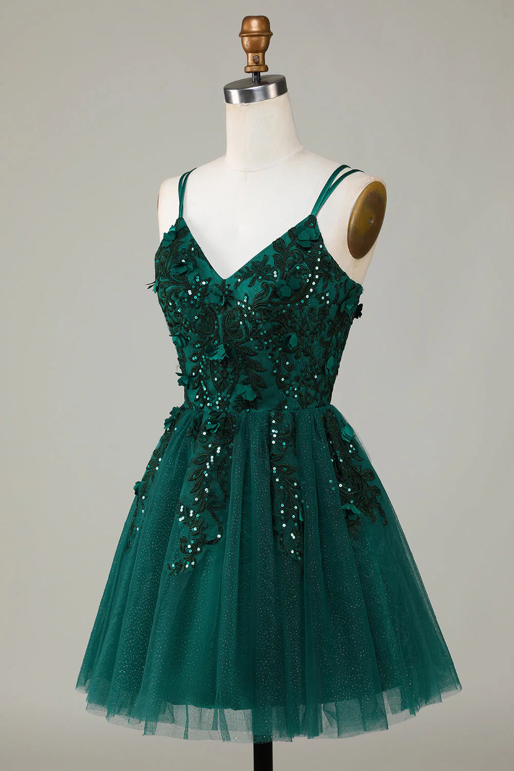 Side view of the dark green A-line dress, highlighting the beading detail.