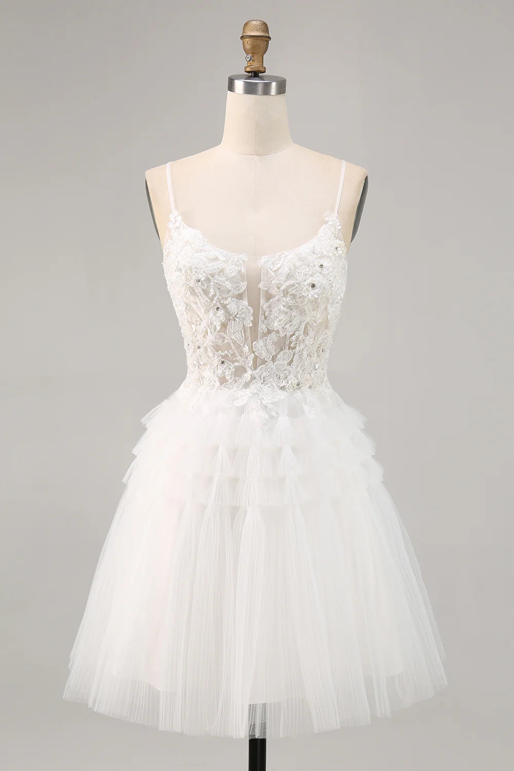 White A-line short homecoming dress with spaghetti straps and sequins.