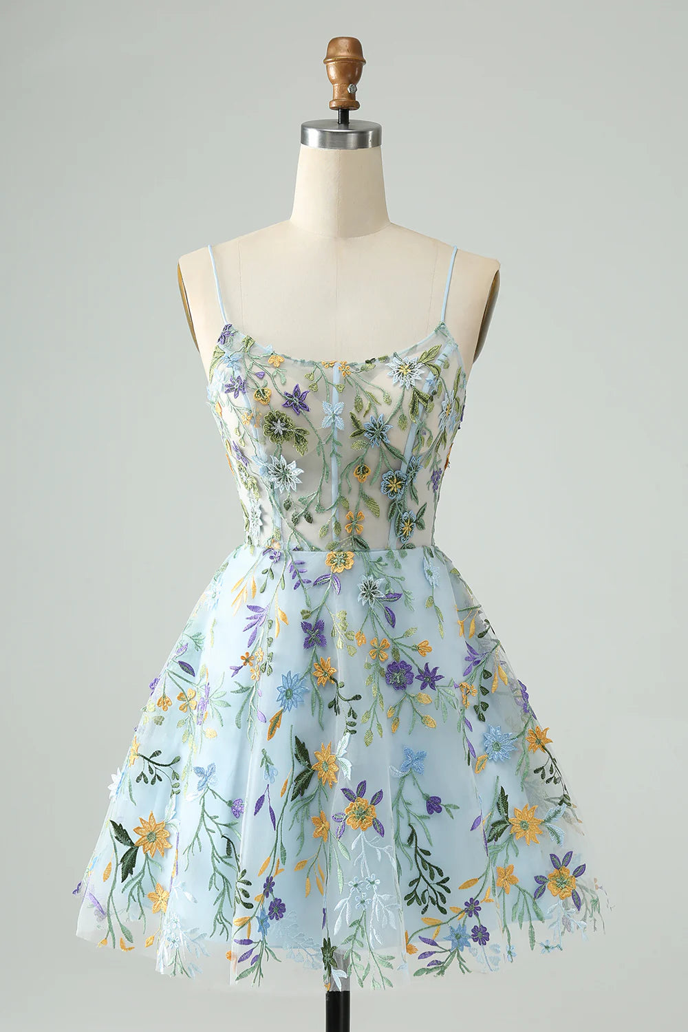 Front view of a blue A-line short homecoming dress with spaghetti straps and floral embroidery.