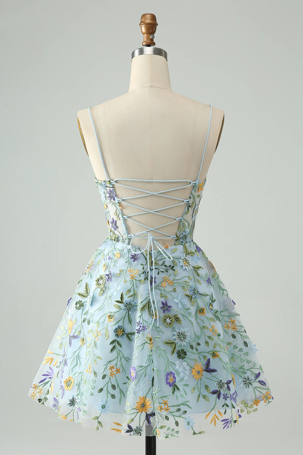 Back view of a blue A-line short homecoming dress with corset lacing detail.