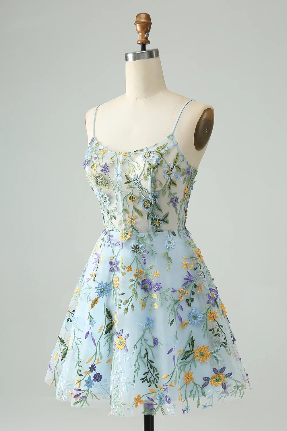 Side view of a blue A-line short homecoming dress with delicate flower embroidery.