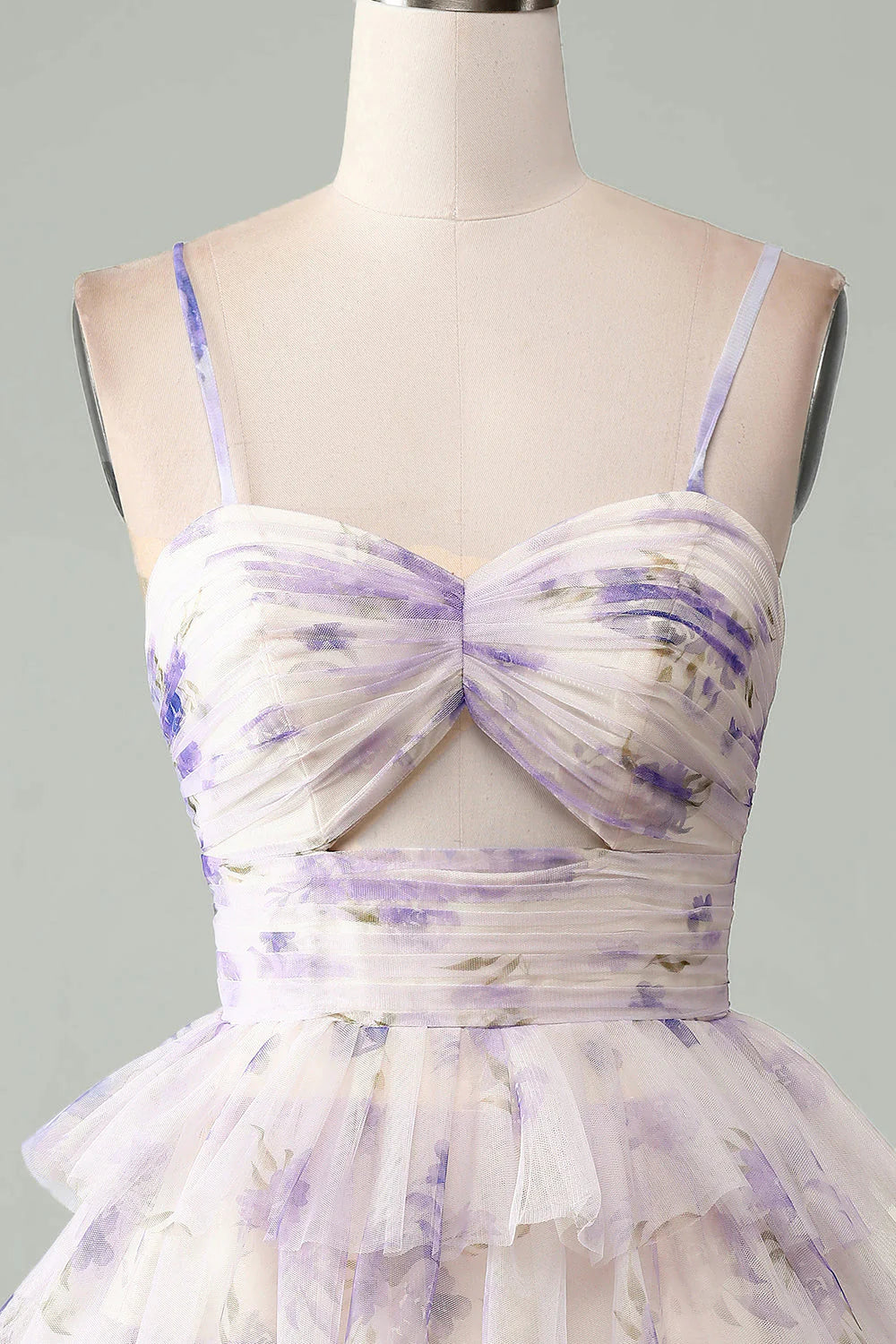 Close-up of the tiered and pleated details on a lavender dress.