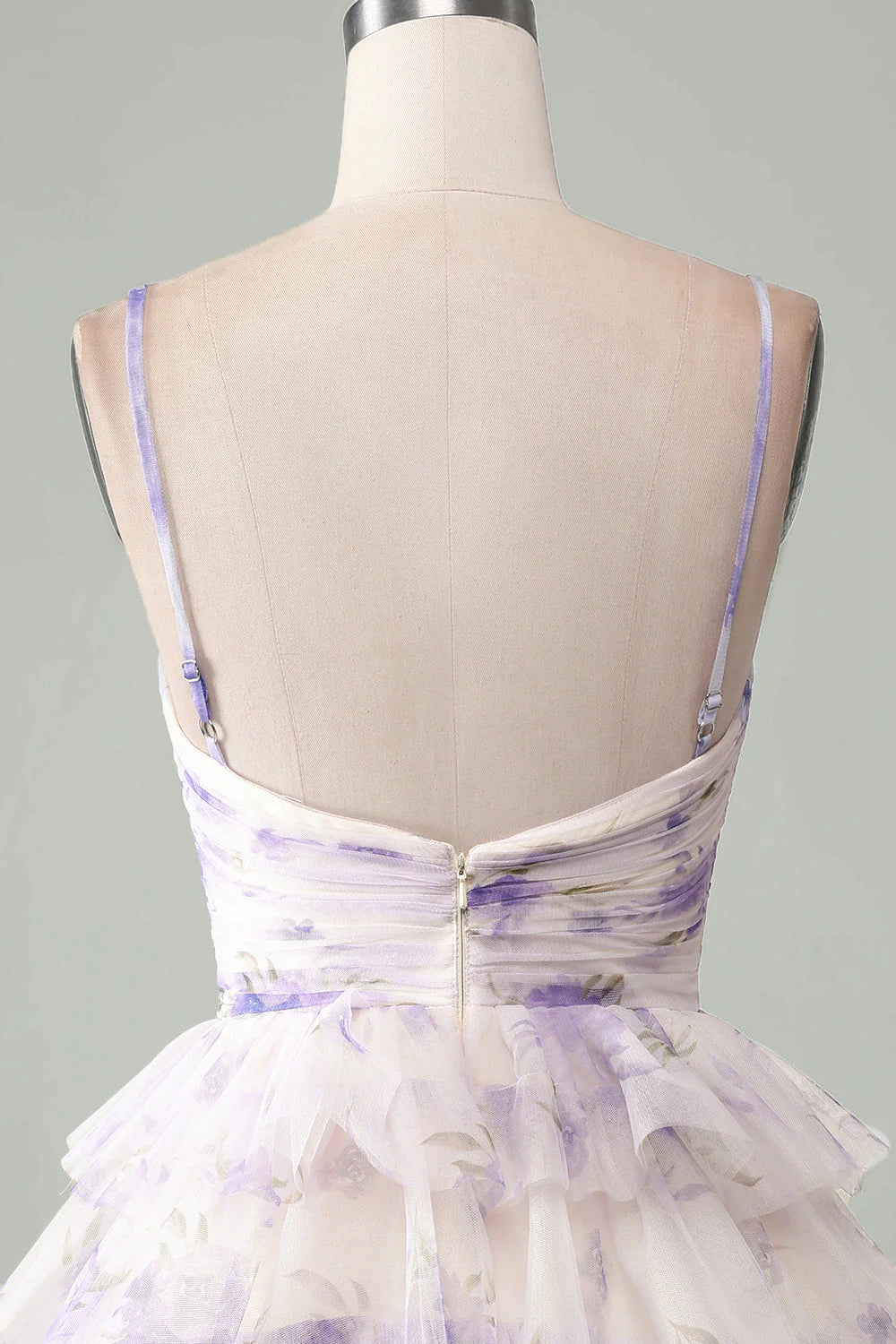 Model posing in a lavender spaghetti strap homecoming dress.