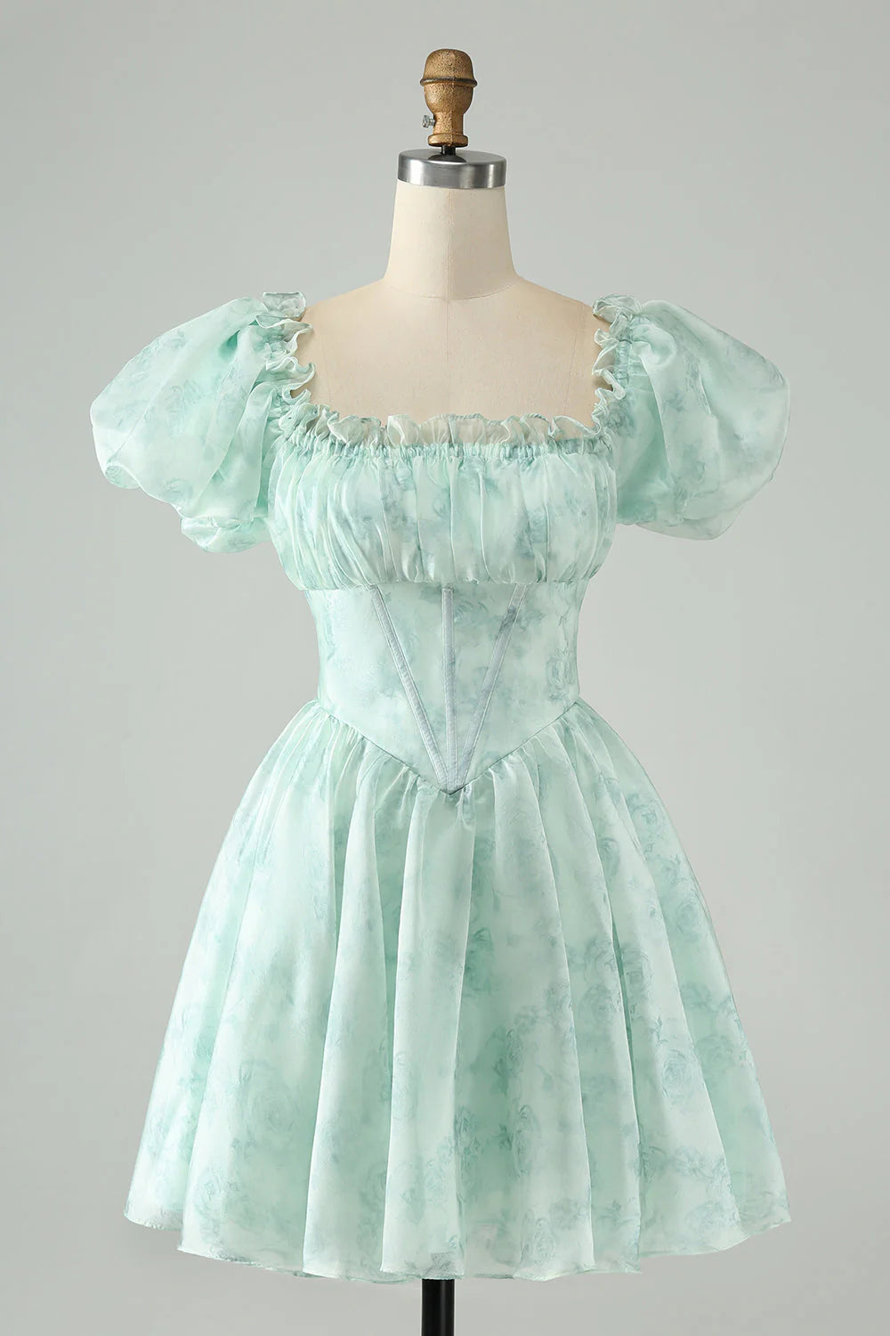 Light green A-line floral short homecoming dress with ruffles, front view.
