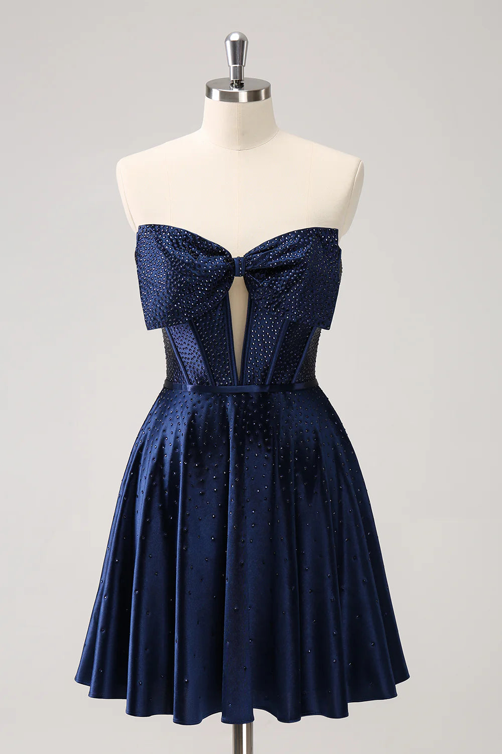 Elegant navy A-line strapless homecoming dress with beaded corset and bow.