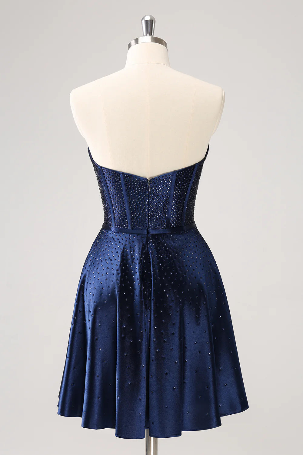 Back view of navy strapless A-line dress showing corset lacing and skirt.