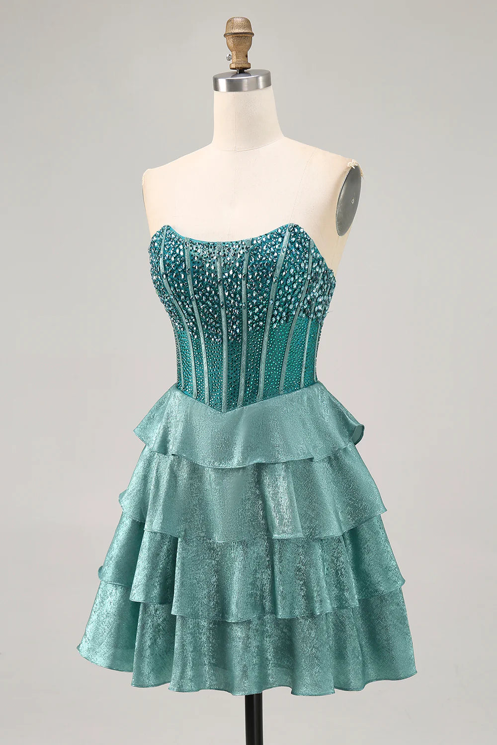 Side view of beaded tiered peacock green dress.