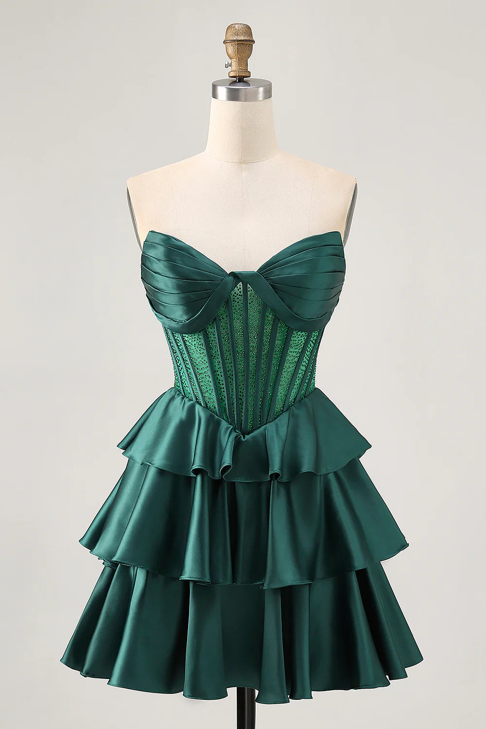Dark green strapless A-line homecoming dress with corset bodice and tiered satin skirt.