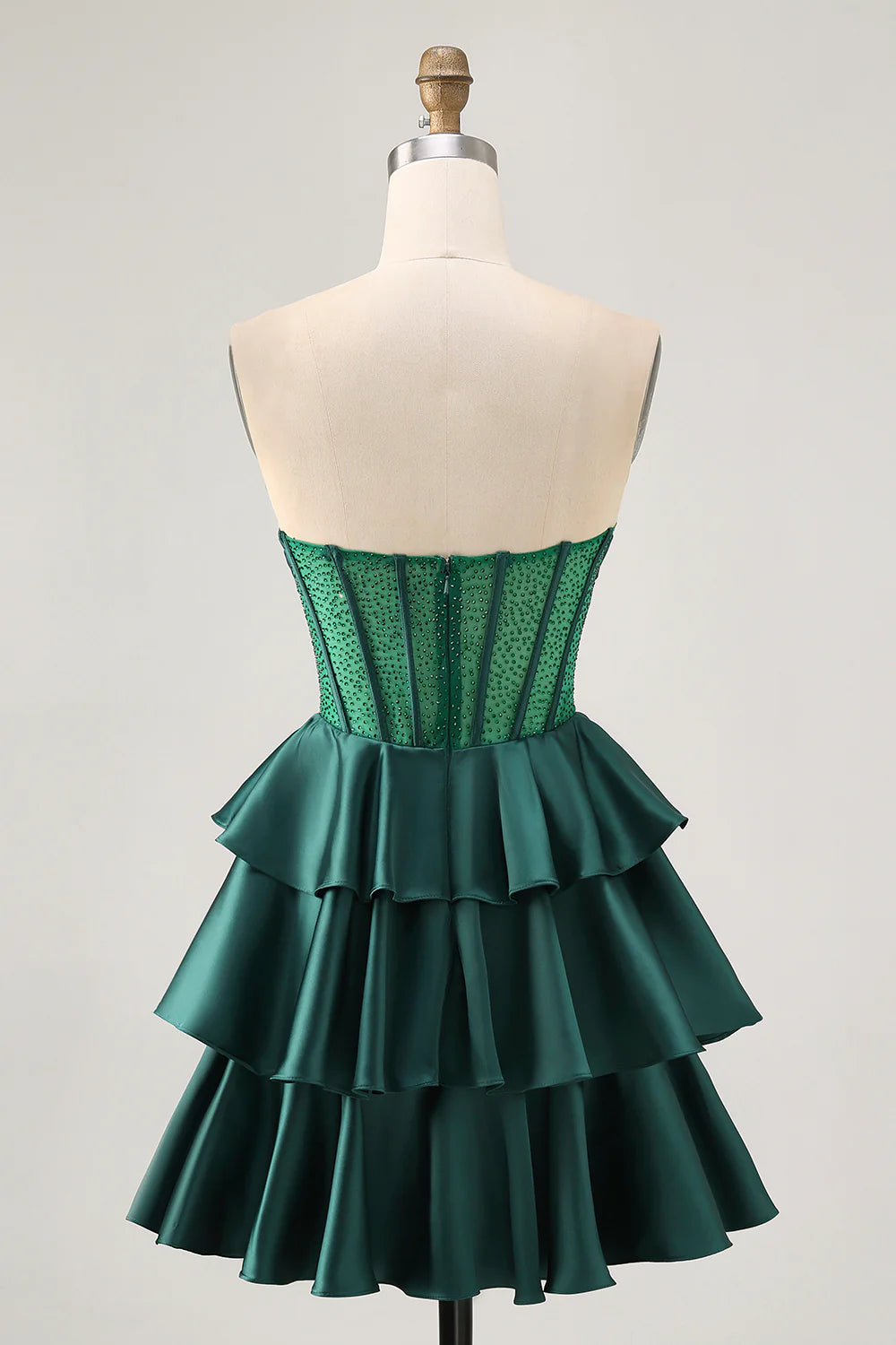 Back view of the dark green strapless homecoming dress, showing tiered skirt detail.