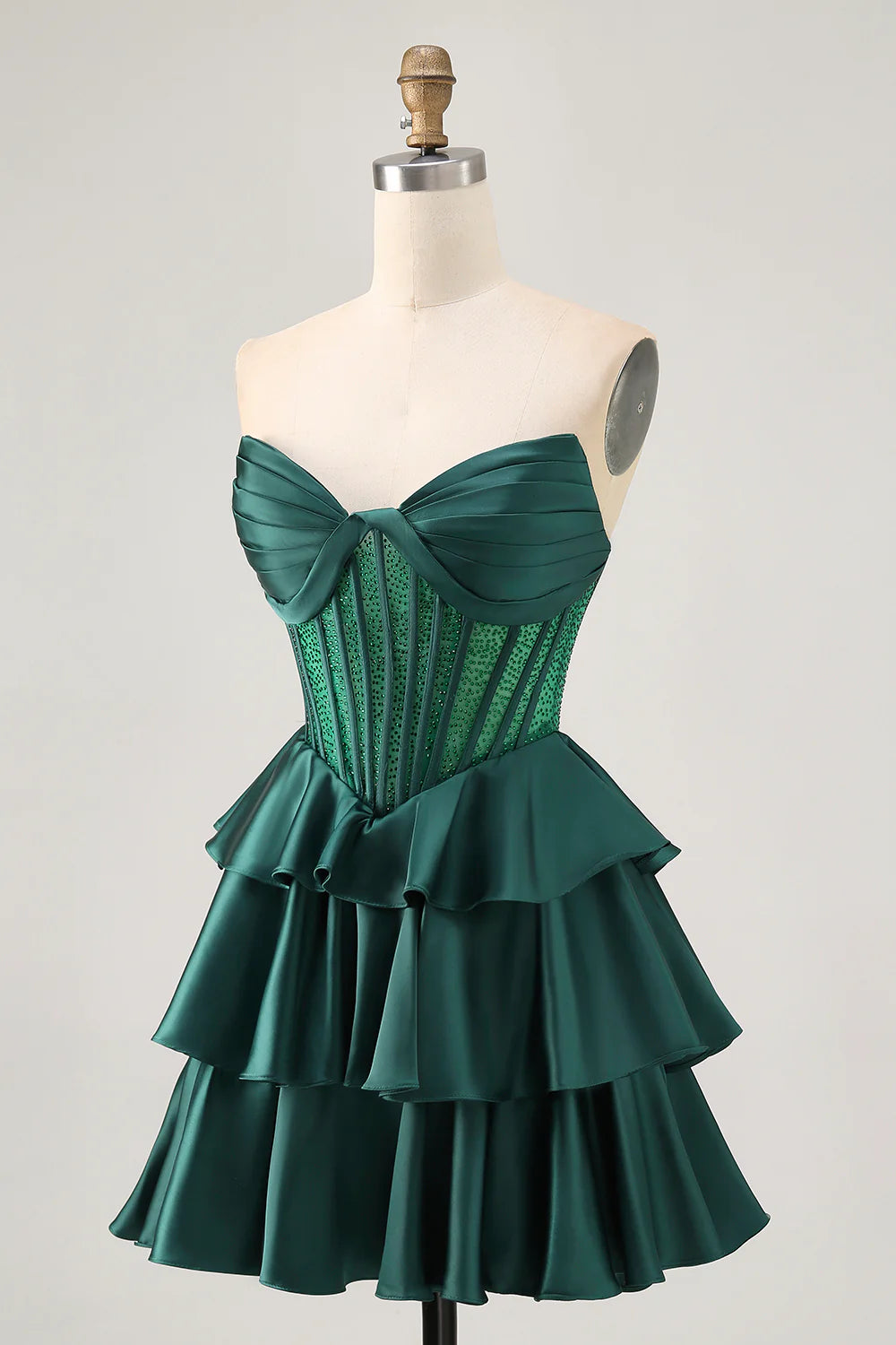 Side view of the dark green strapless A-line dress, highlighting beaded corset.