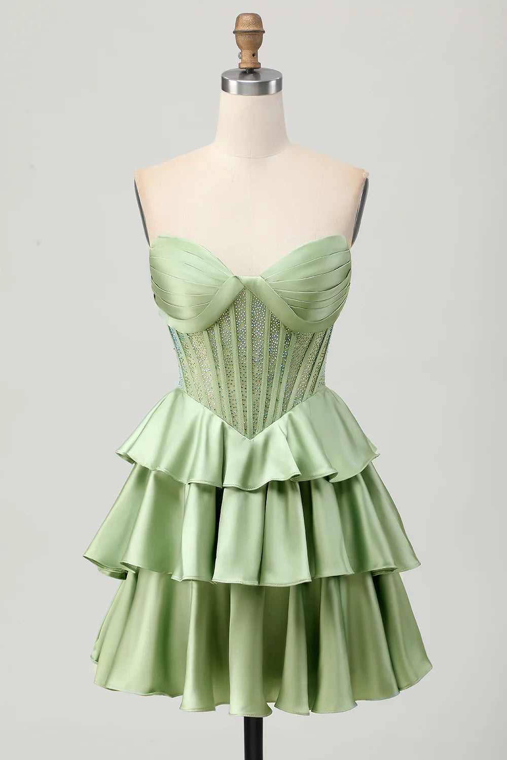 Close-up of the beaded corset bodice on the dark green satin dress.