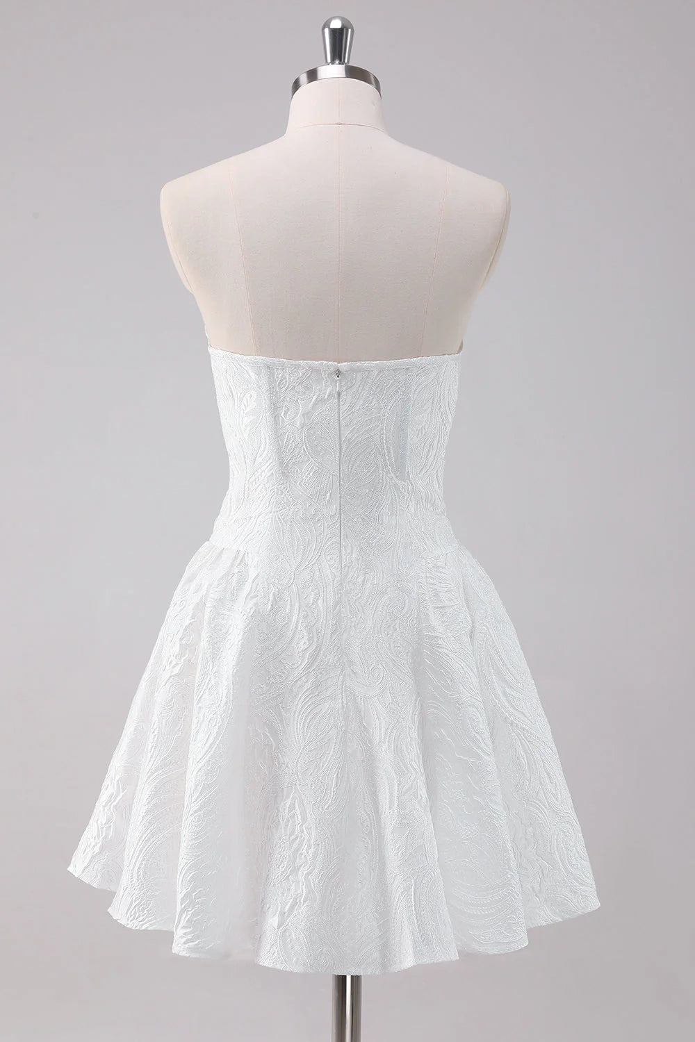 Side view of a model in a white strapless A-line homecoming dress, showcasing the flowing skirt.