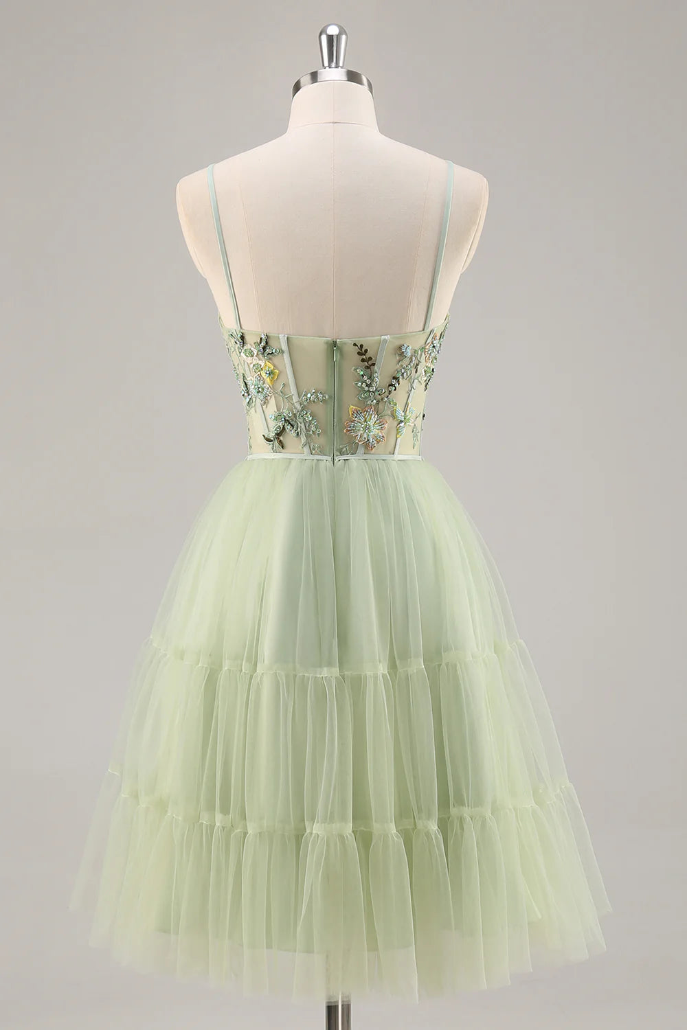 Side view of a green A-line short dress, showcasing floral embroidery and beading.