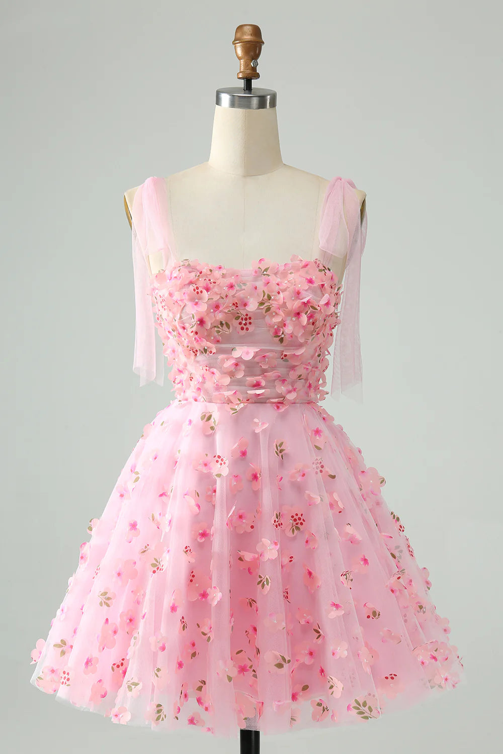 Pink A-line short homecoming dress with corset bodice, pearls, and floral appliques.