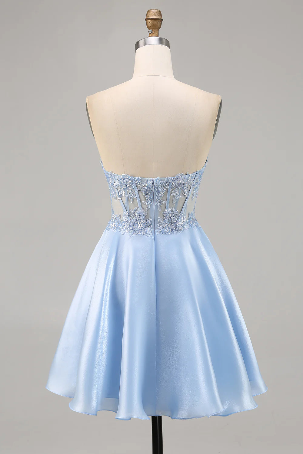Back view of a light blue strapless A-line satin homecoming dress with appliques.