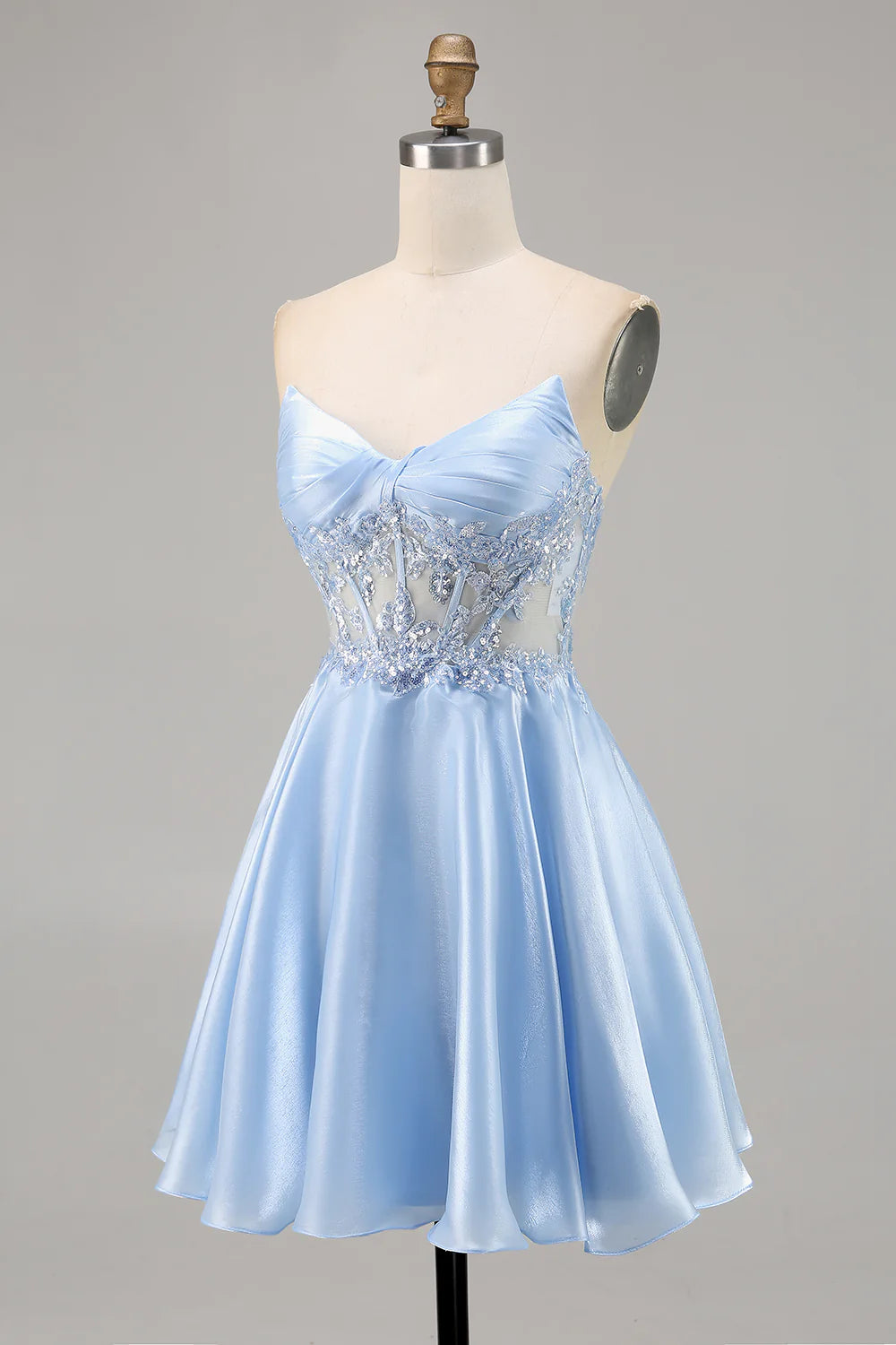 Side view of a light blue strapless A-line satin homecoming dress with appliques.