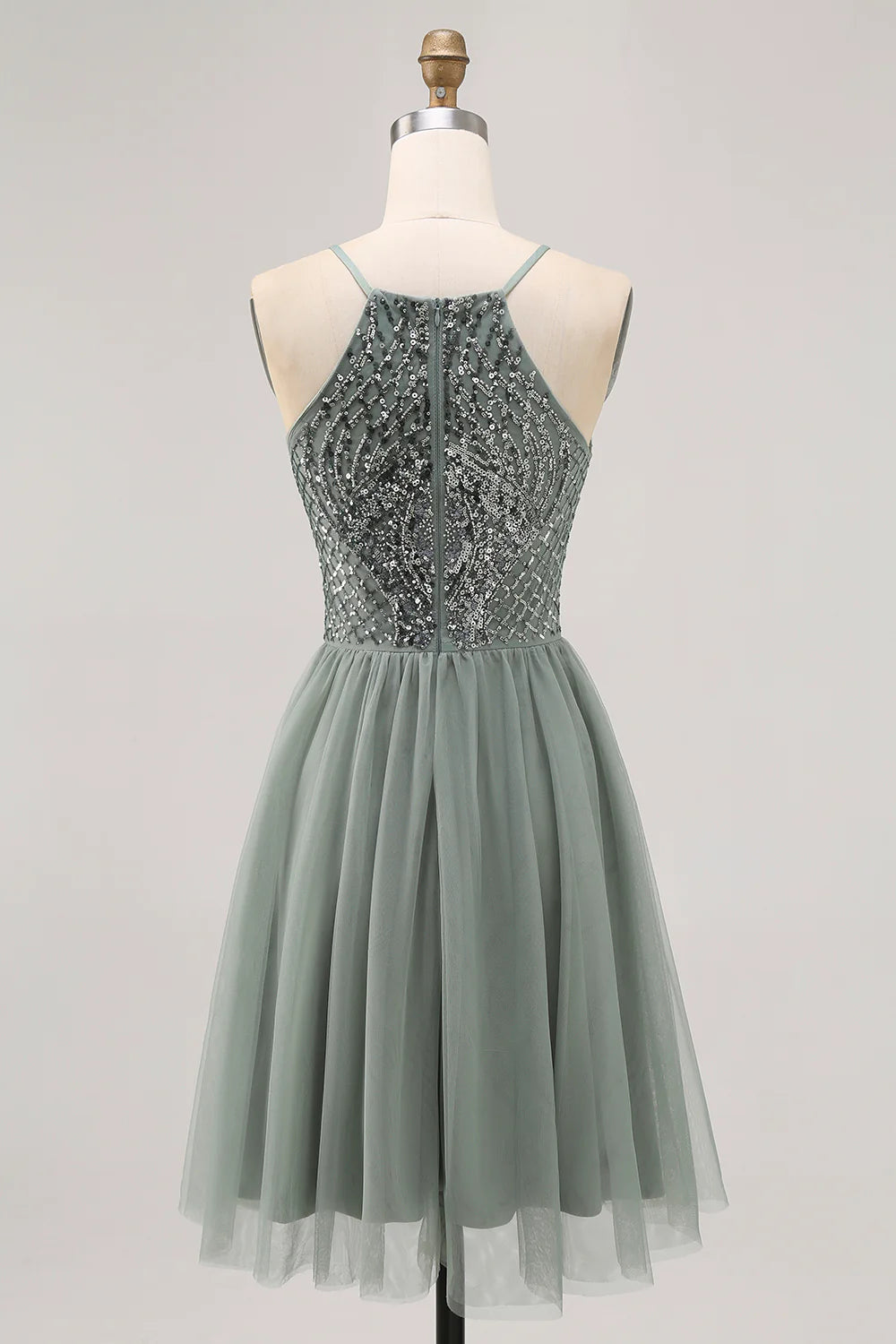 Side view of a model in a grey blue A-line sequin tulle short homecoming dress, highlighting the skirt.