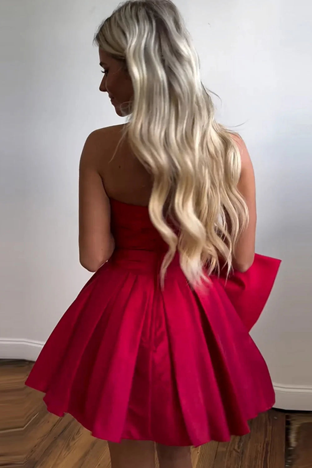 Back view of the A-Line strapless short satin dress, showing the bowknot detail.
