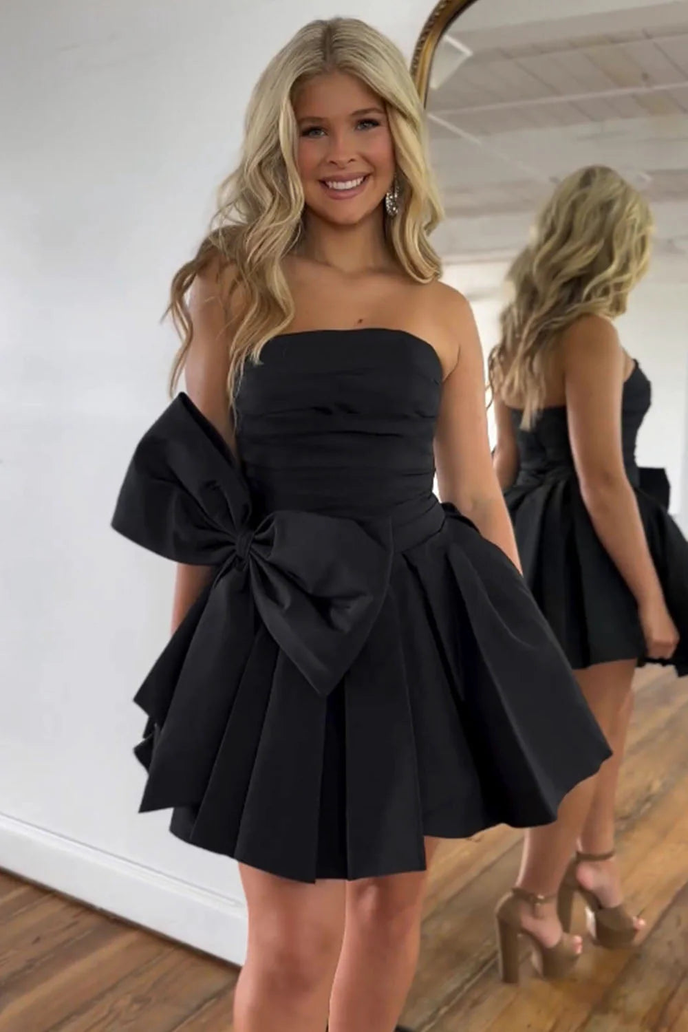 Close-up of the satin fabric and bowknot on the strapless homecoming dress.