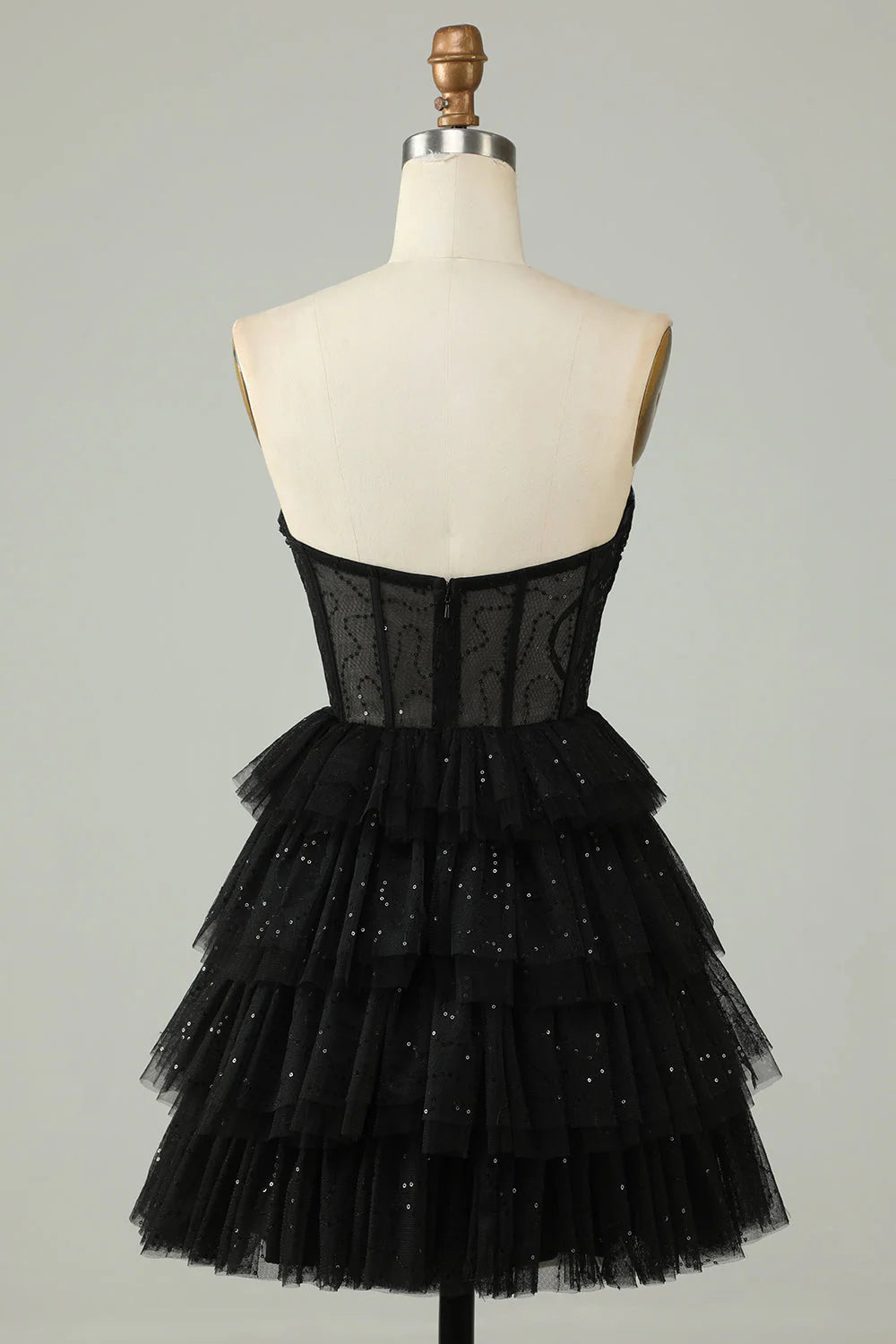 Side view of black A-line strapless tiered homecoming dress.