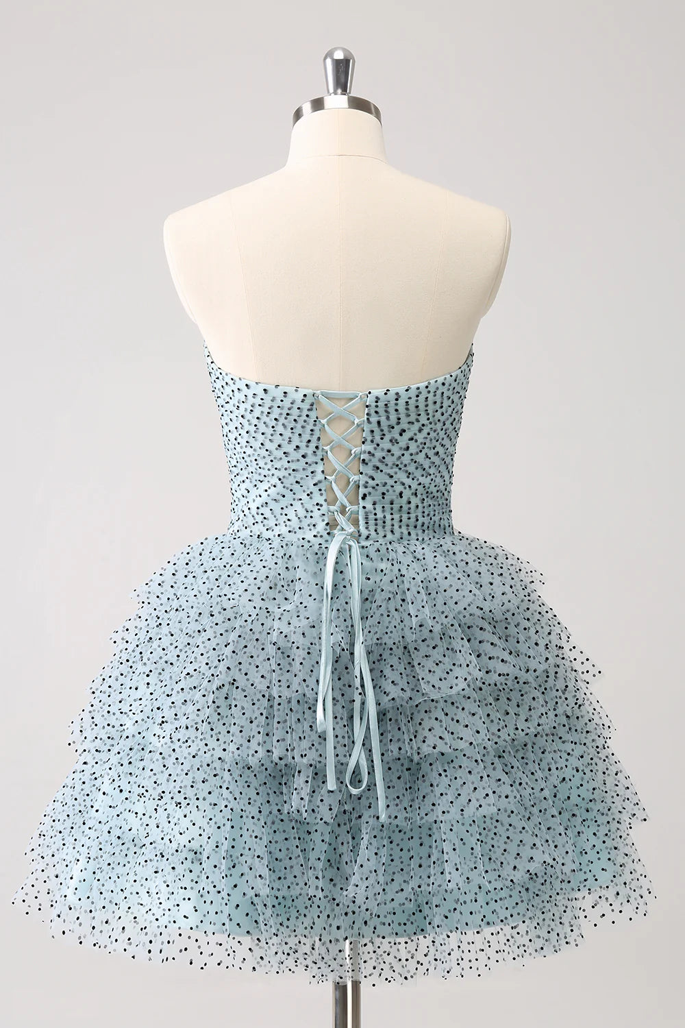 Back view of blue A-line strapless tiered ruffle dress.