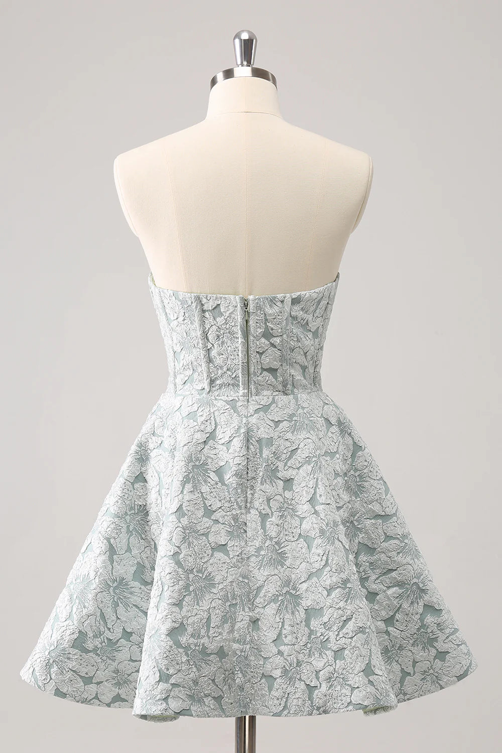 Side view of a model wearing a grey green A-line satin homecoming dress.
