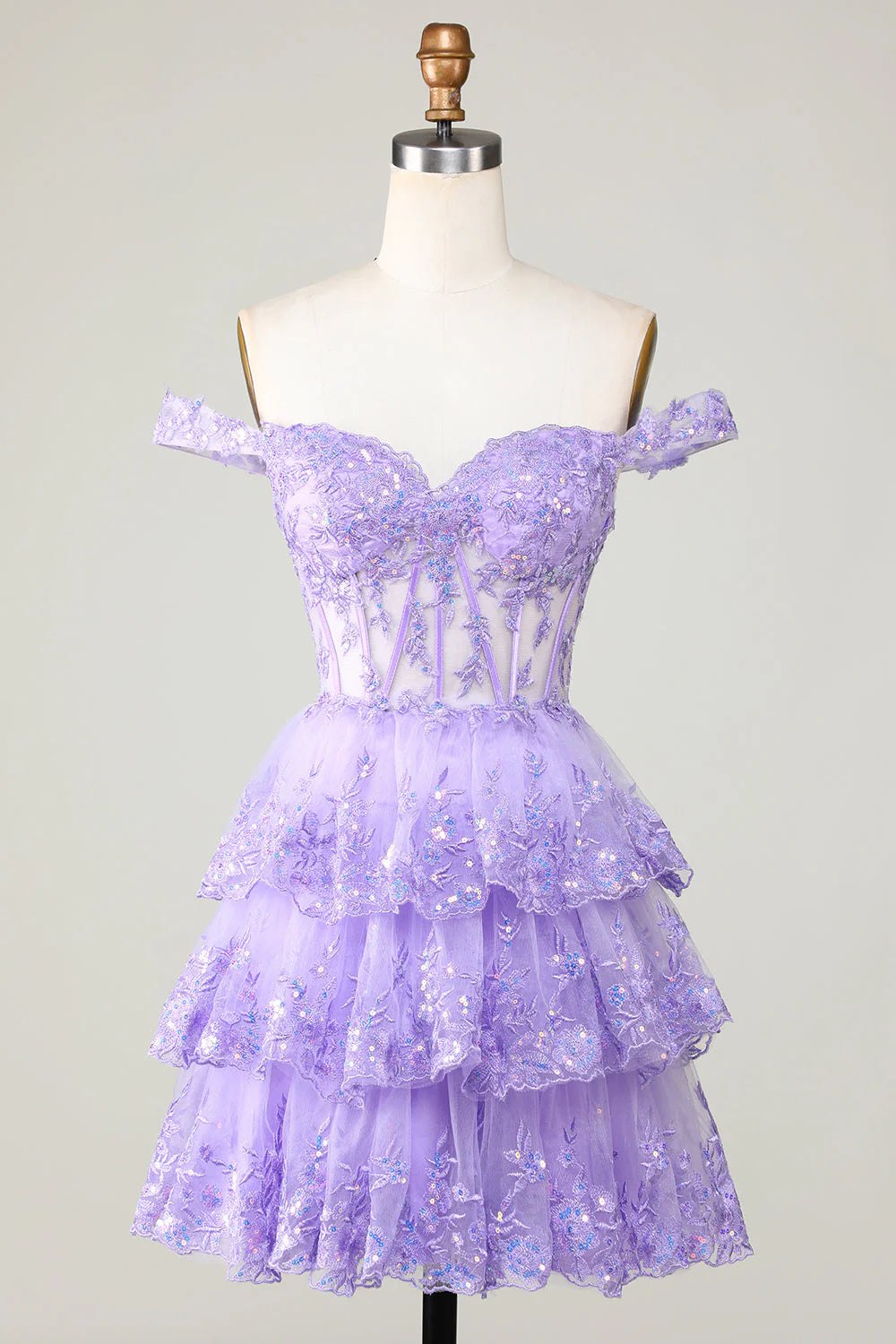 Model wearing a purple A-line short homecoming dress with a corset bodice and tiered lace skirt.