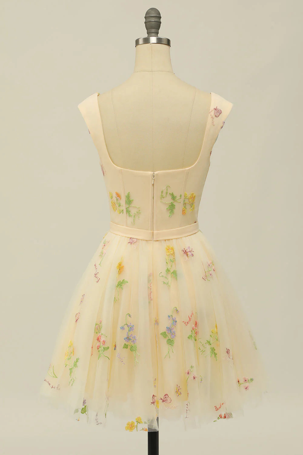 Detail of the champagne A-line homecoming dress, showing the fabric and design.