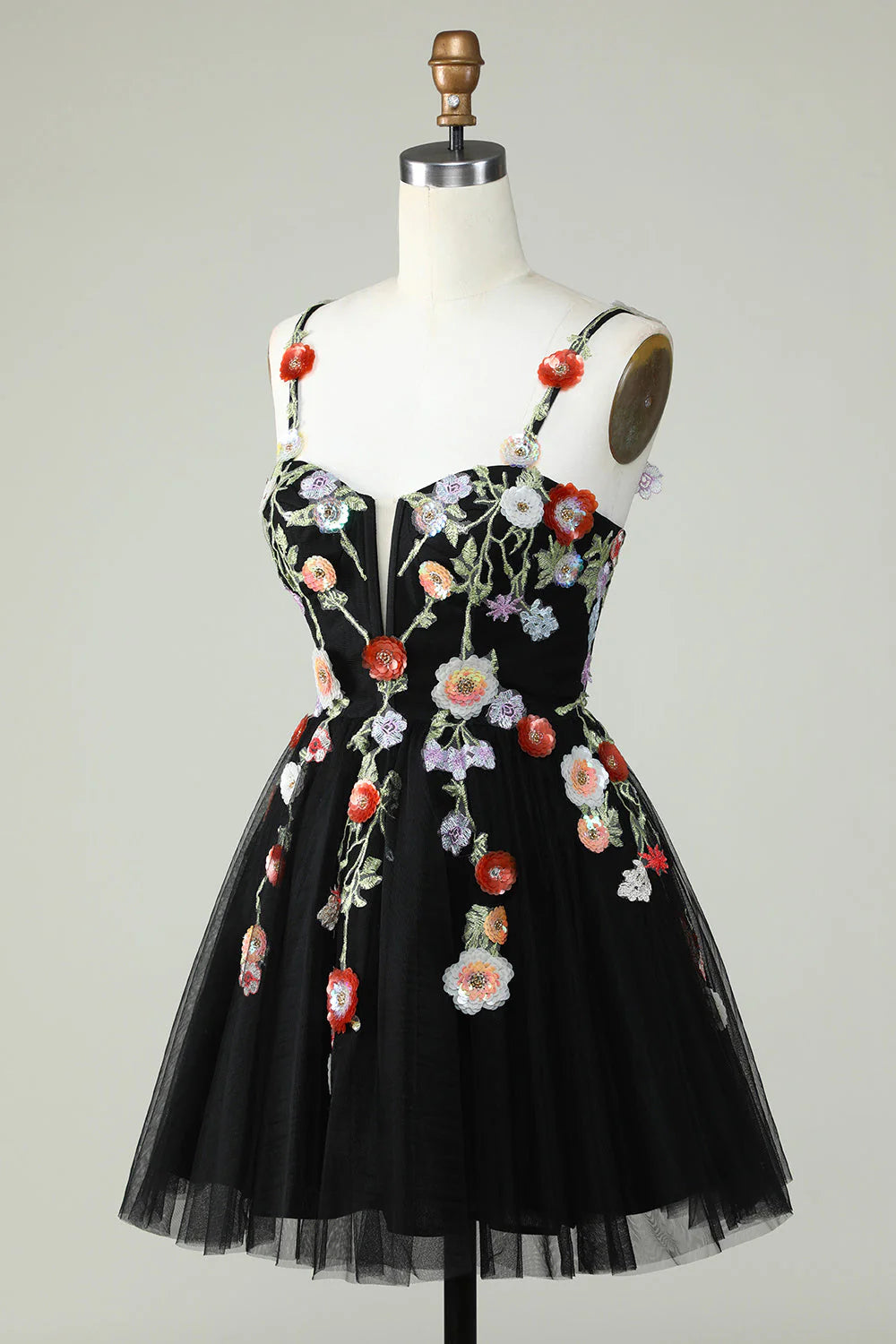 Close-up of the sequin and floral embellishments on a black dress.
