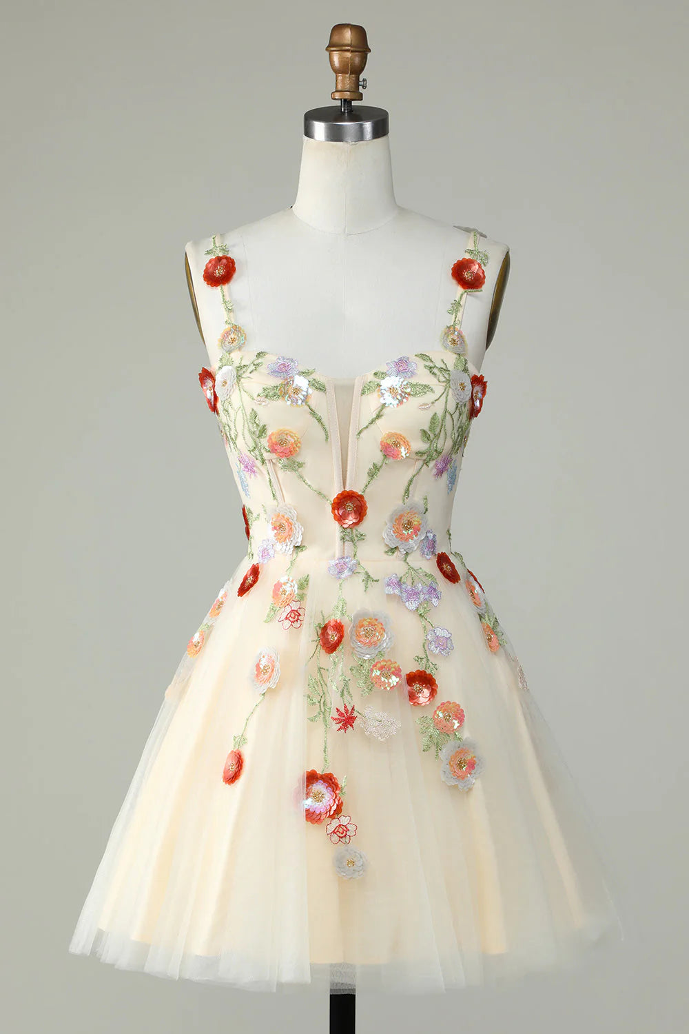 Champagne A-line homecoming dress with spaghetti straps and sequin floral details.