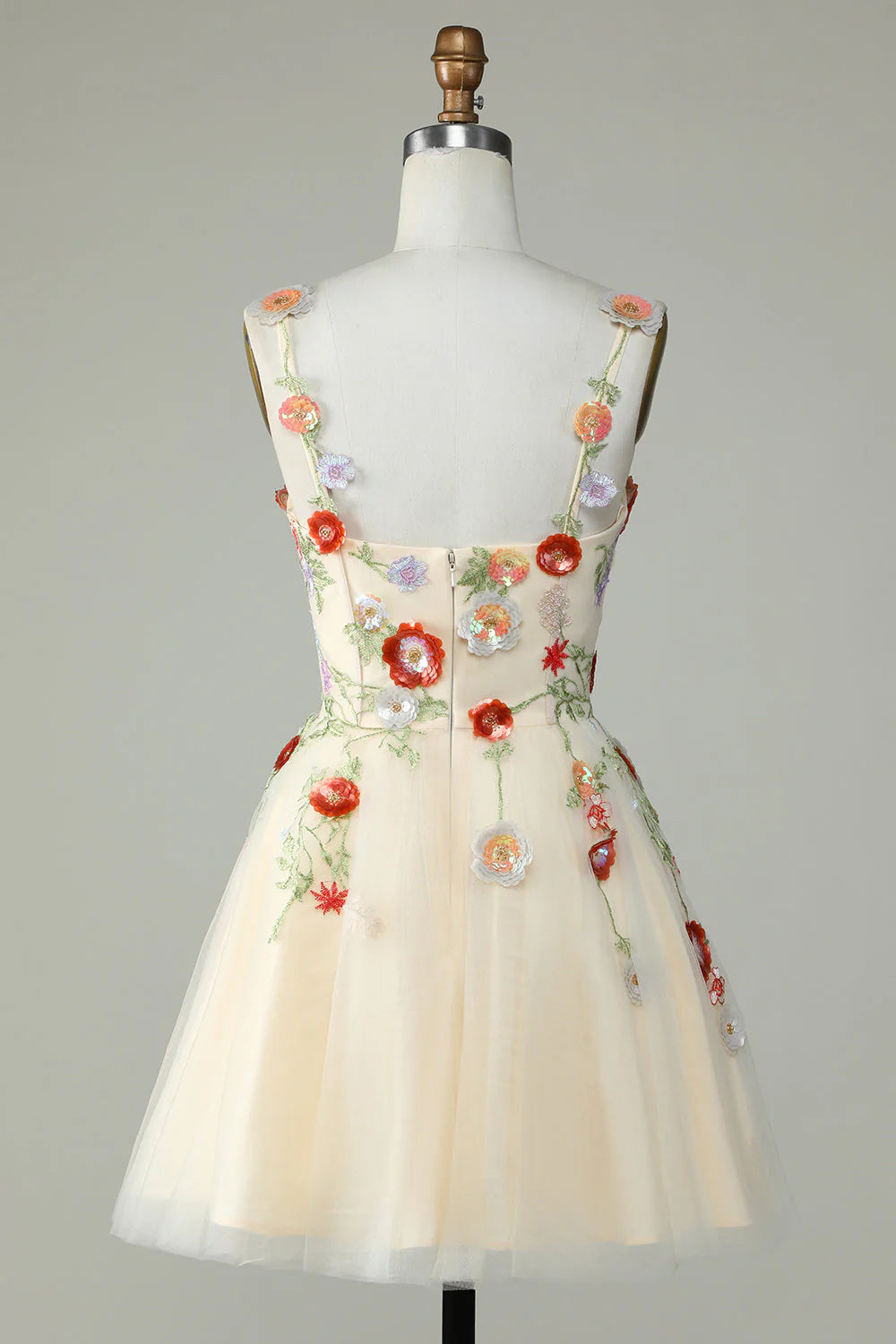 Back view of a champagne A-line sequin homecoming dress with delicate straps.