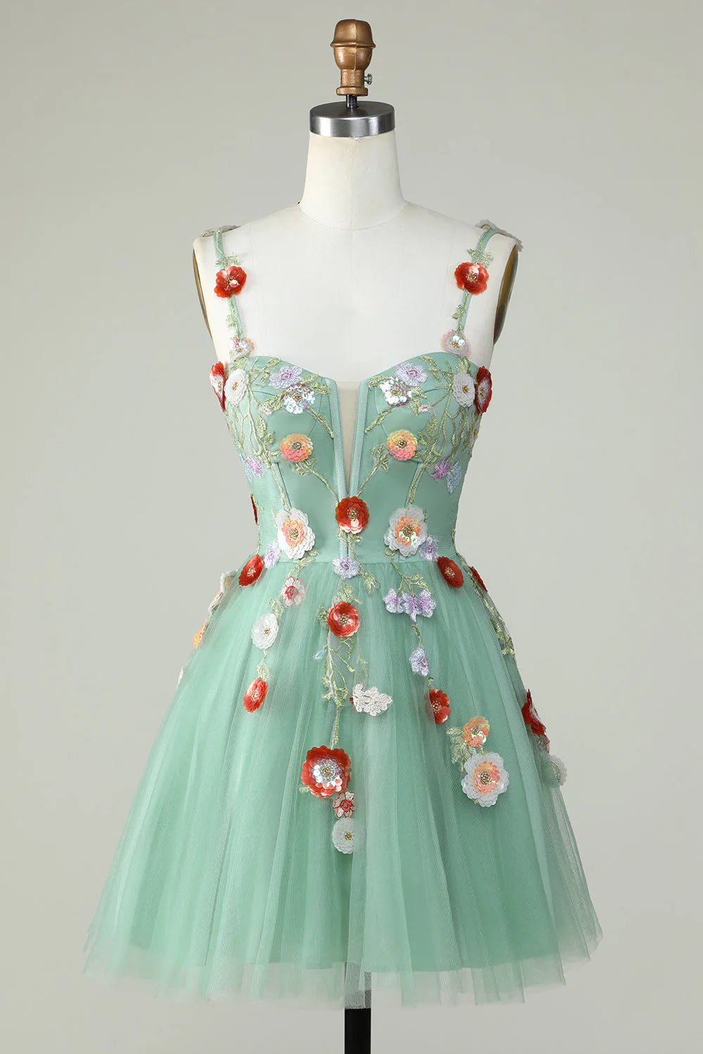 Light green A-line homecoming dress with spaghetti straps and sequin floral details.