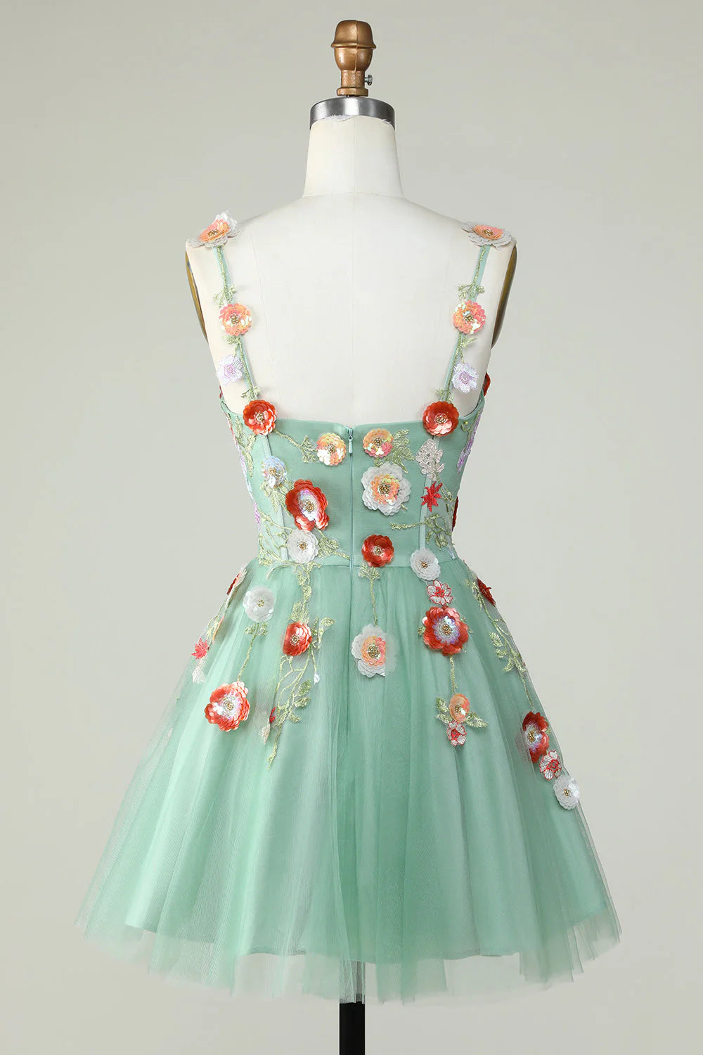 Back view of a light green A-line sequin homecoming dress with delicate straps.