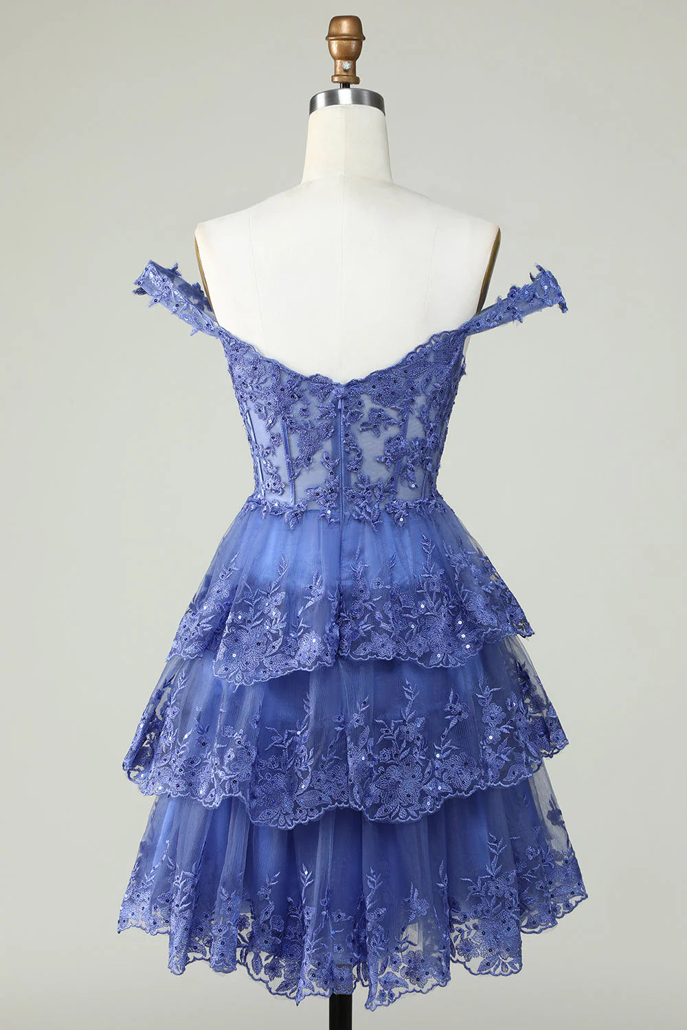 Back view of the dark blue tiered homecoming dress, showcasing lace details and corset back.