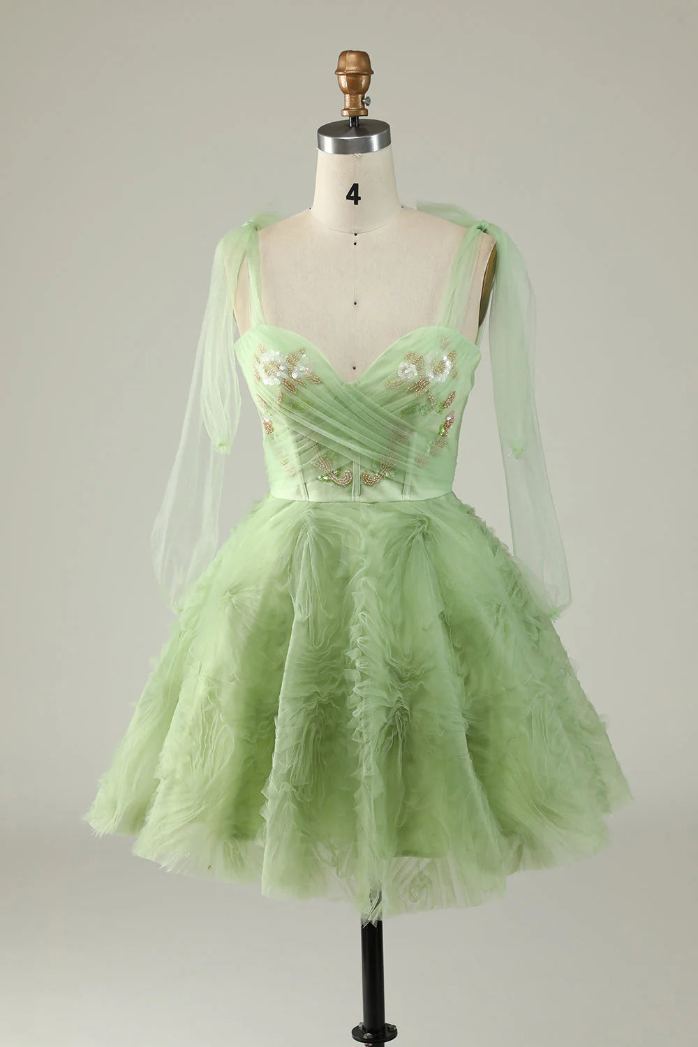 Green A-line short homecoming dress featuring a sweetheart neckline, appliques, and sequins.