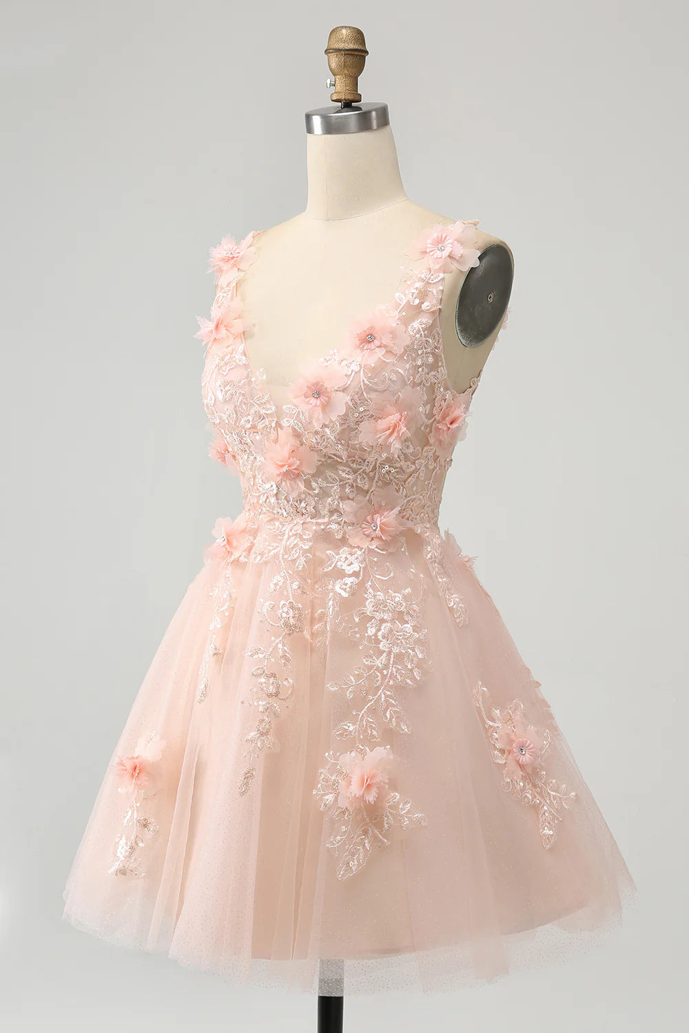 Close-up of sequin and applique details on blush homecoming dress.