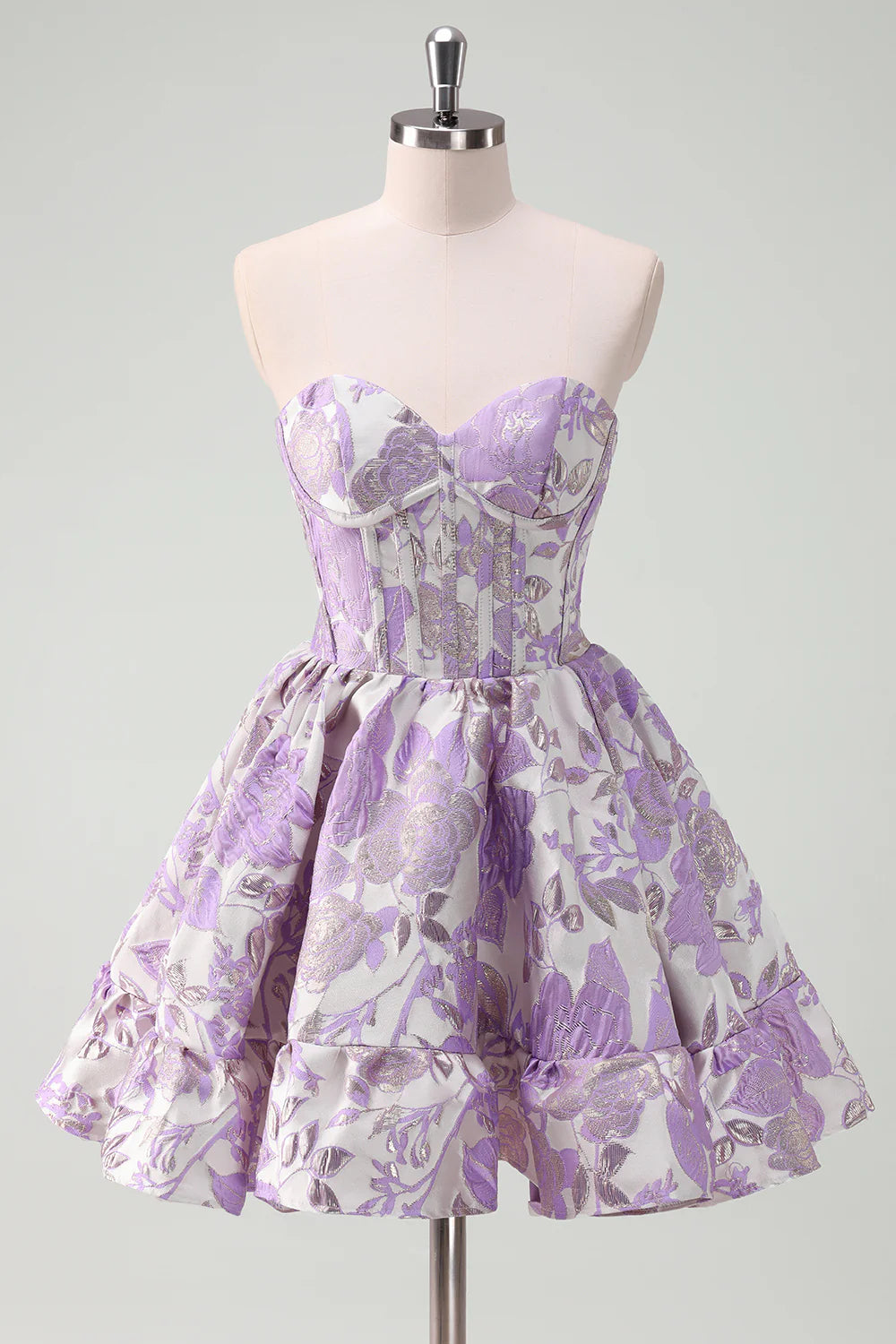 Model wearing a lilac sweetheart satin ball gown homecoming dress with ruffles.
