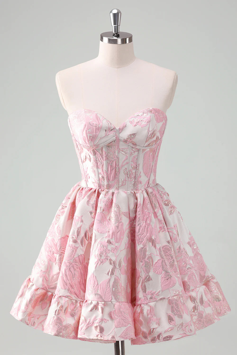 Model wearing a blush sweetheart satin ball gown homecoming dress with ruffles.