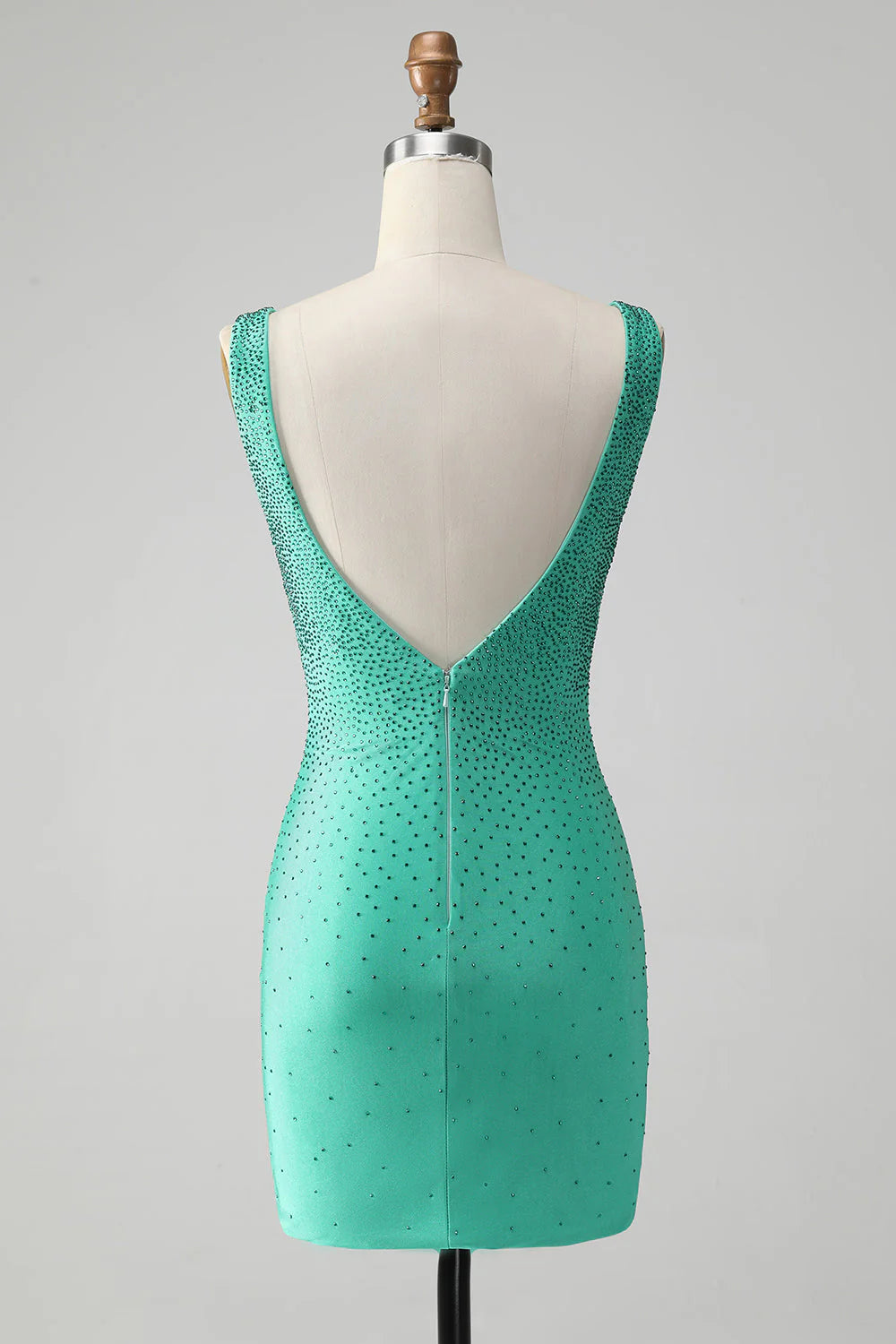 Back view of a green bodycon V-neck short homecoming dress showcasing the backless design and beading.