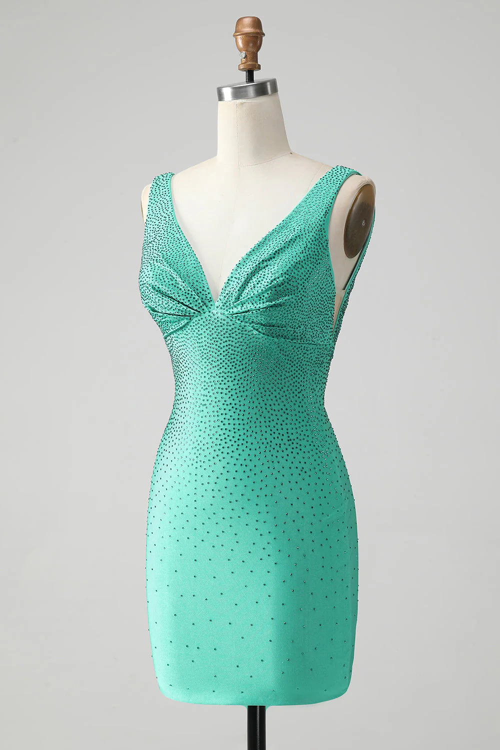 Side profile of a sparkling green bodycon short dress with V-neck and beading, ideal for homecoming.