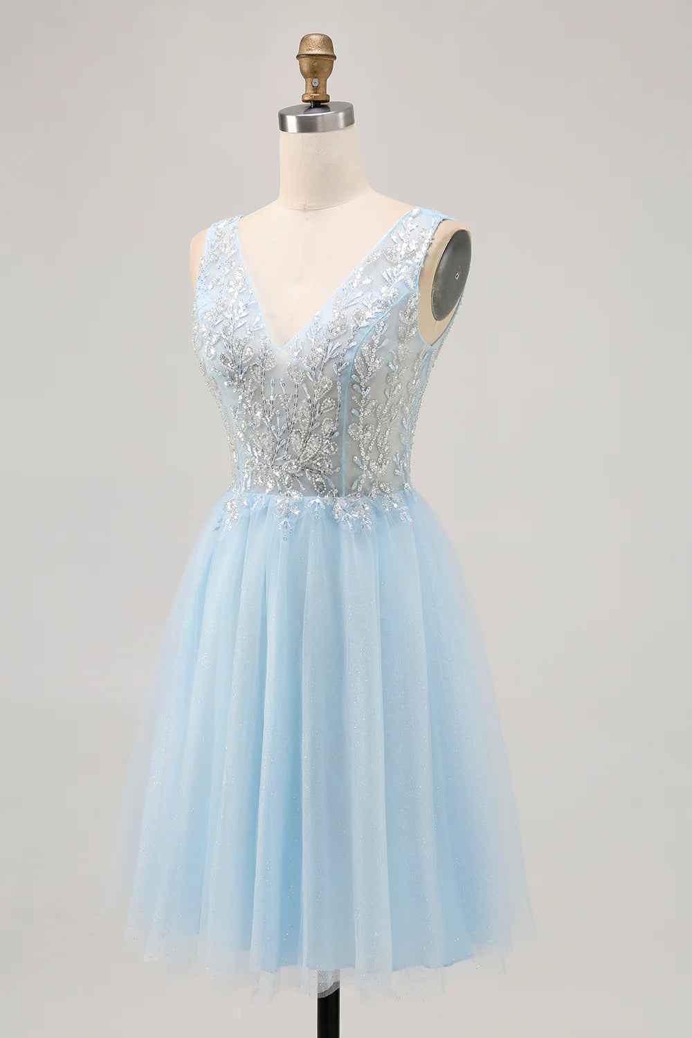 Close-up of floral appliques on a blue homecoming dress.