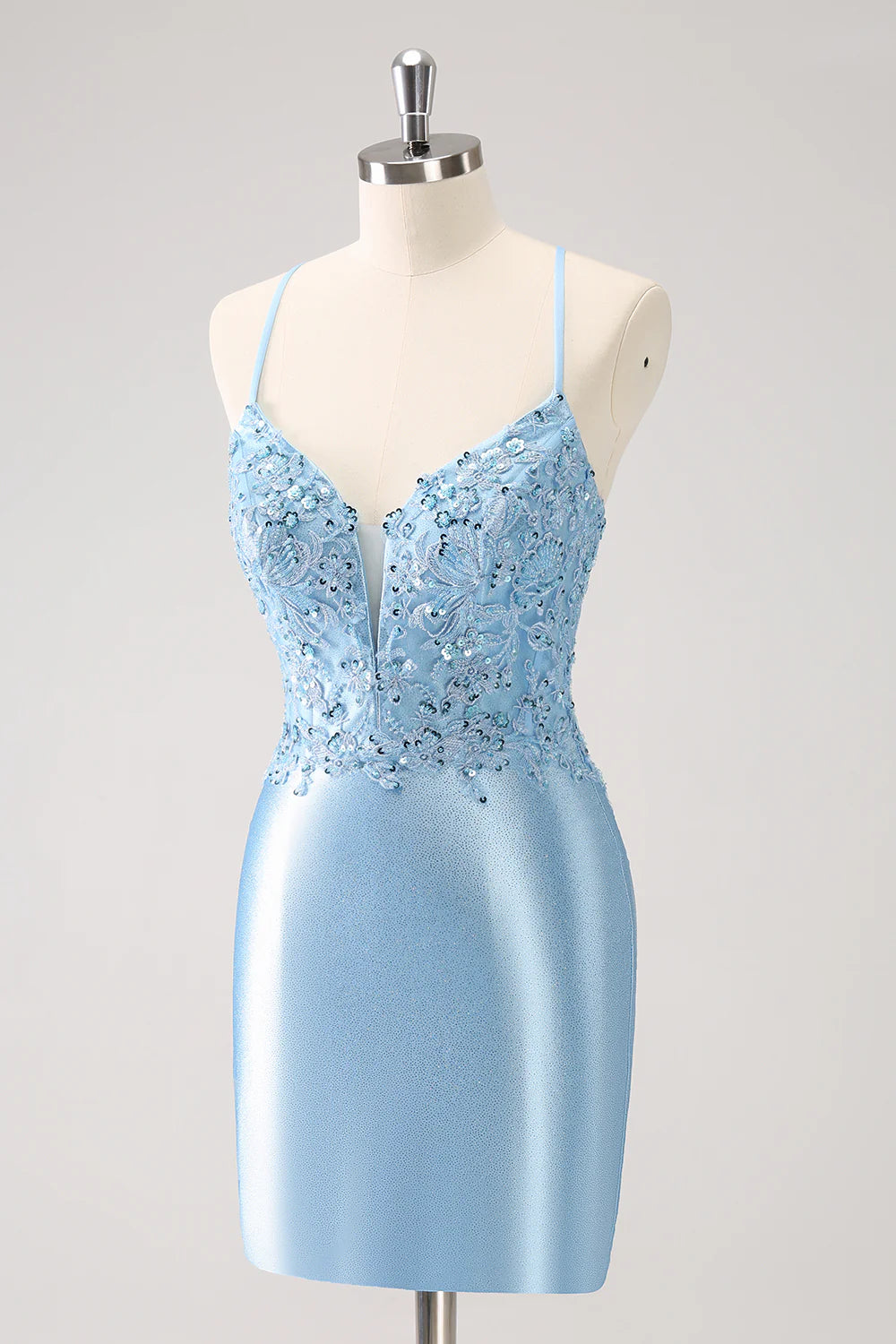 Close-up of the intricate lace-up back detail on a sparkling blue sequin dress.
